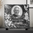 Négyzet alakú, rusztikus szélű palakő kegyeleti fotókő fekete talpakon. Közepén egy elhunyt ovális portréja látható, mellette fehér liliomok, rózsák, égő gyertya, repülő fehér galamb és égi fénysugarak. Alatta az elhunyt neve, születési és halálozási évszáma, valamint egy egyedi kegyeleti búcsúfelirat olvasható.